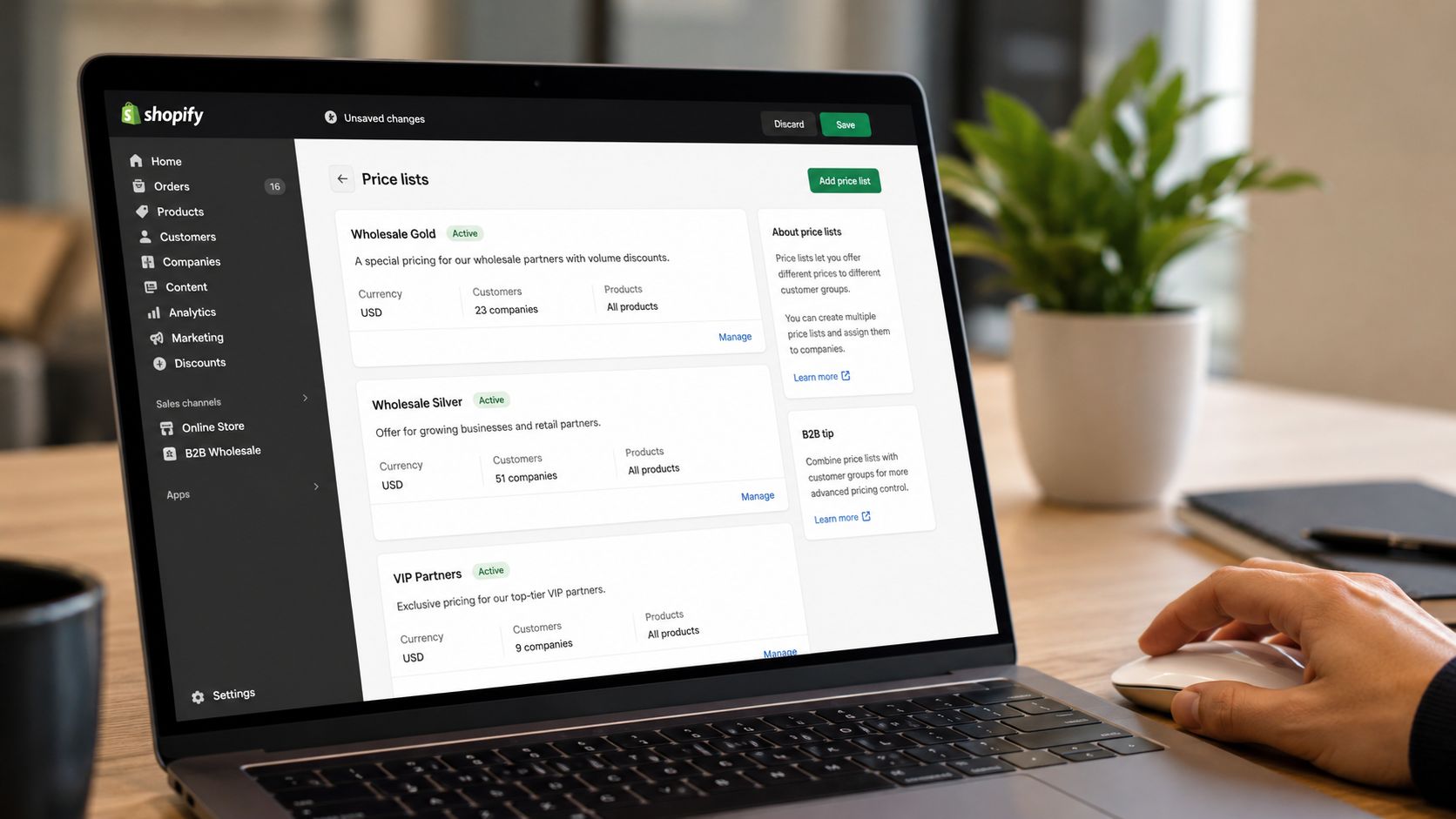 A laptop screen displaying the Shopify admin dashboard, specifically showing the price lists page for B2B settings.